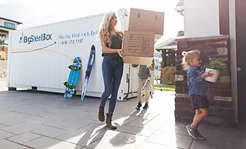 Family unpacking their BigSteelBox after a move