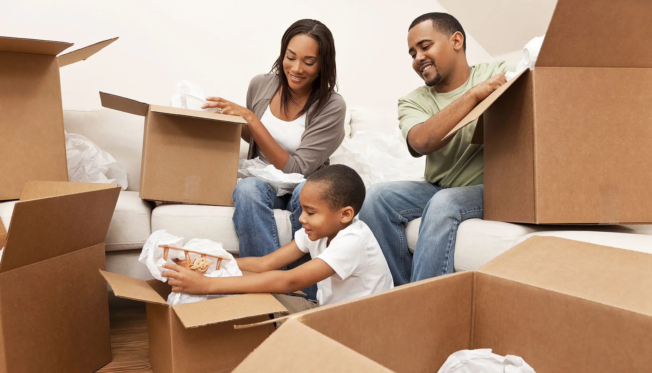 Family unpacking moving boxes after a move