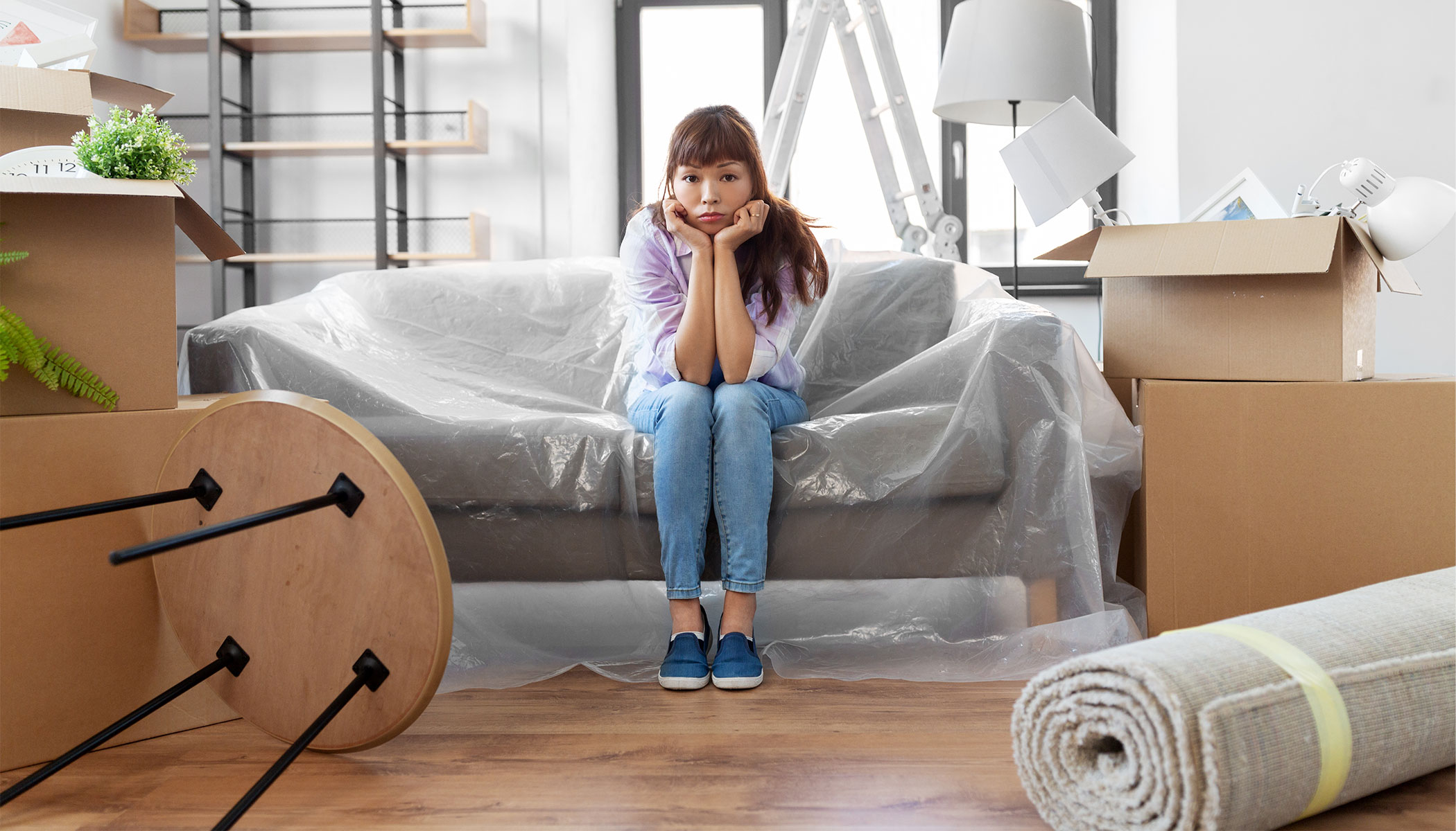 Woman feeling the stress of moving out after a breakup